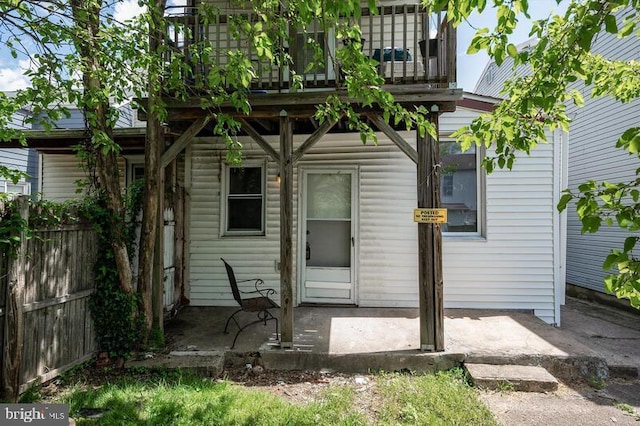 rear view of property with a balcony and a patio