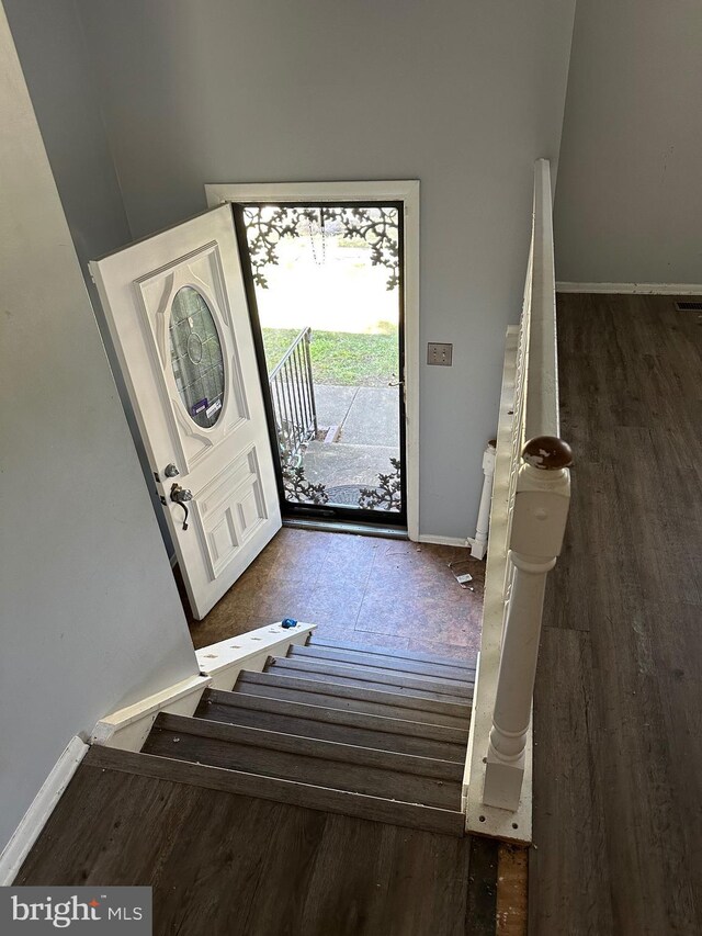 foyer entrance featuring wood finished floors and baseboards