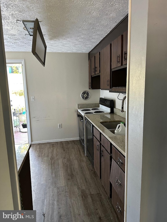 kitchen with electric range oven, dishwashing machine, dark wood-style floors, light countertops, and a textured ceiling