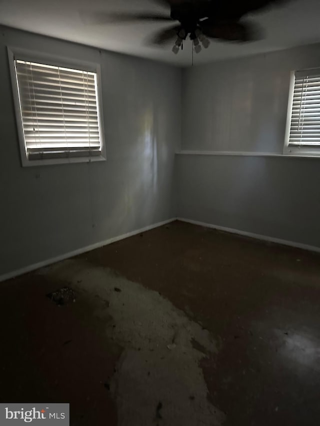 spare room with concrete floors and ceiling fan