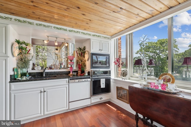 kitchen with white cabinetry, hardwood / wood-style floors, black appliances, and wood ceiling