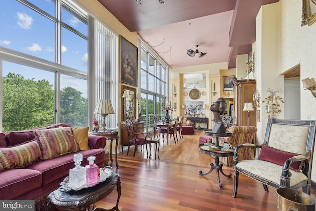 living room featuring a high ceiling and wood-type flooring