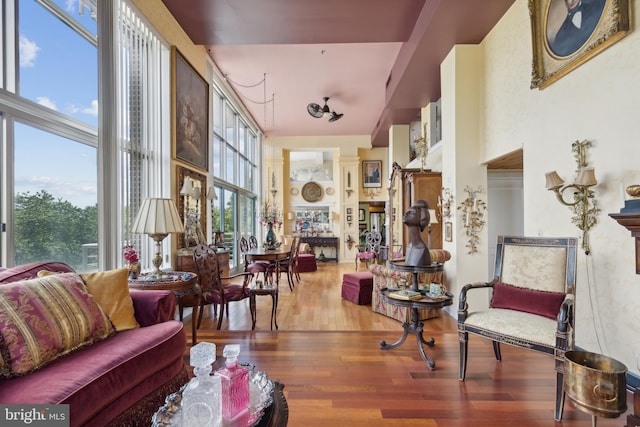 living room featuring a towering ceiling and hardwood / wood-style flooring