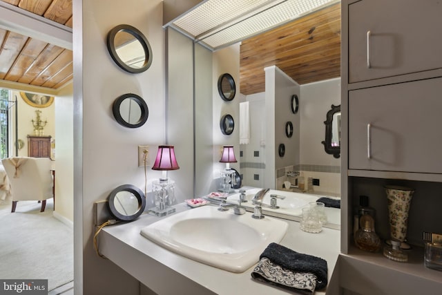 bathroom featuring wood ceiling and large vanity