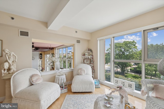 living room featuring a wealth of natural light, hardwood / wood-style flooring, and ceiling fan