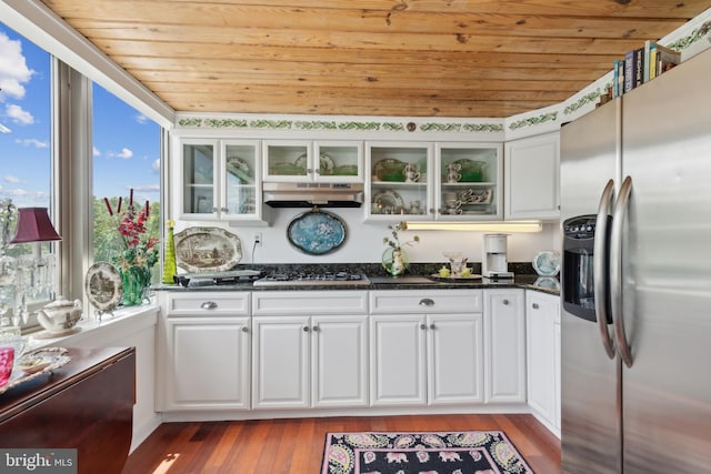 kitchen with stainless steel appliances, hardwood / wood-style flooring, and wood ceiling