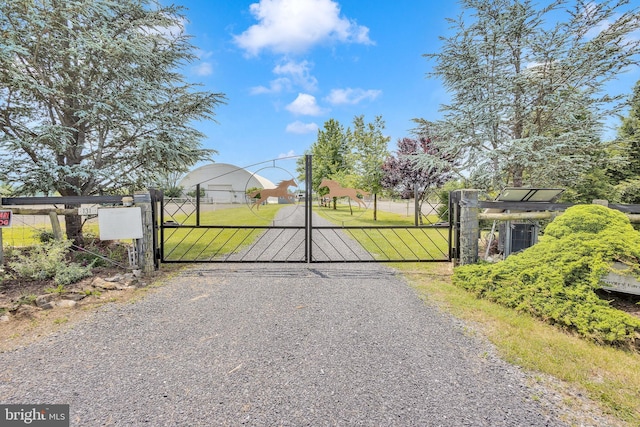 view of gate featuring a lawn