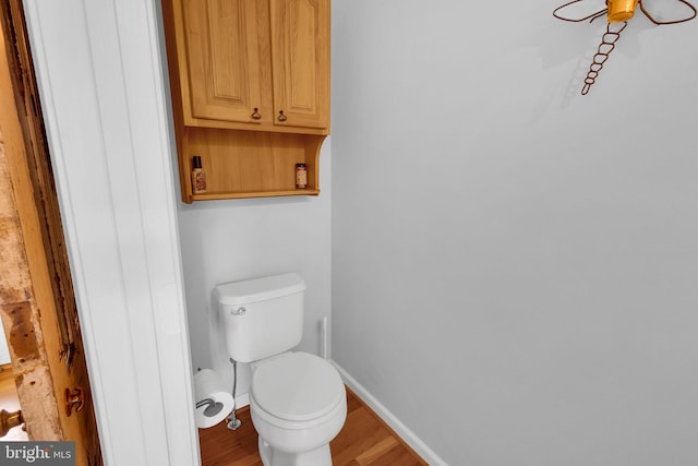 bathroom featuring hardwood / wood-style flooring and toilet