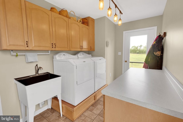 washroom with washer and dryer, cabinets, and light tile patterned floors