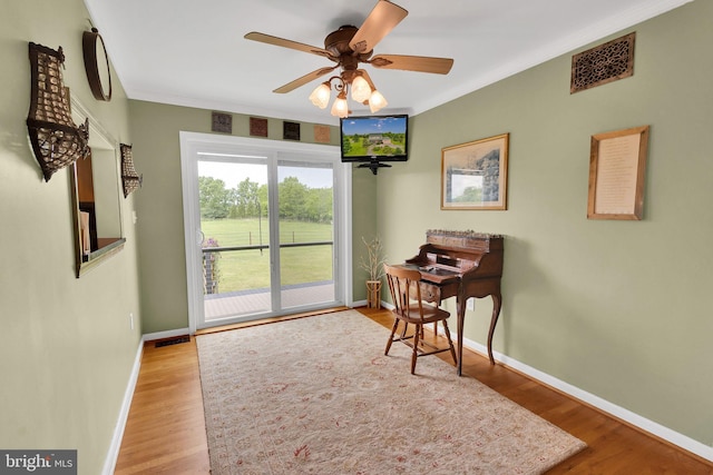 interior space featuring ceiling fan, light hardwood / wood-style flooring, and crown molding