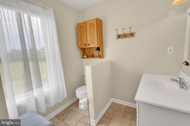 bathroom with tile patterned floors, vanity, and toilet