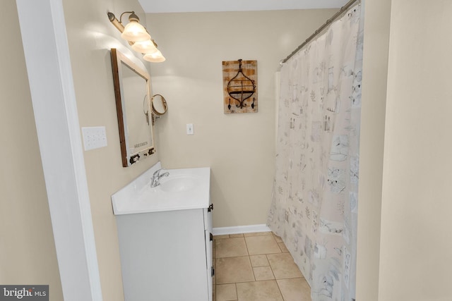 bathroom featuring tile patterned flooring, vanity, and curtained shower