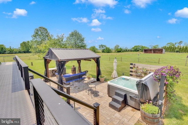 view of patio featuring a gazebo, grilling area, a rural view, and a hot tub