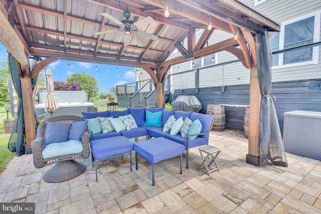 view of patio / terrace with outdoor lounge area, ceiling fan, a gazebo, grilling area, and a hot tub