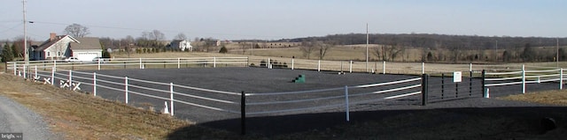 view of horse barn featuring a rural view