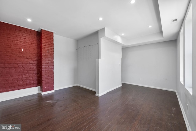 spare room featuring dark hardwood / wood-style flooring