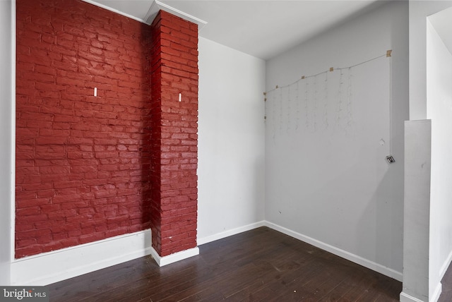 unfurnished room with dark wood-type flooring