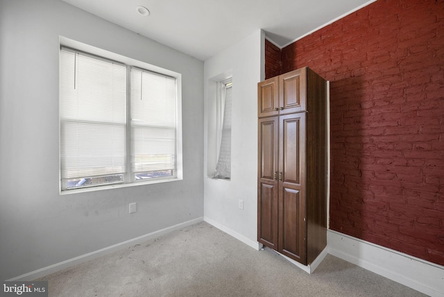 spare room with light colored carpet and plenty of natural light