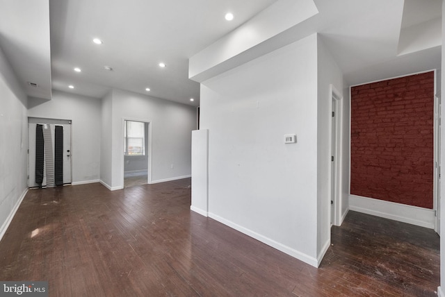 empty room with dark hardwood / wood-style floors