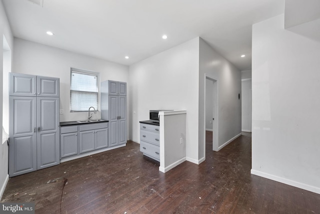 kitchen with dark hardwood / wood-style floors, sink, and gray cabinets