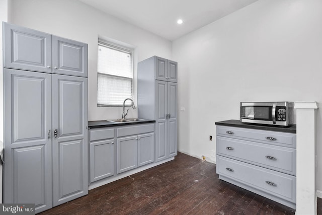 kitchen with dark hardwood / wood-style floors, sink, and gray cabinetry