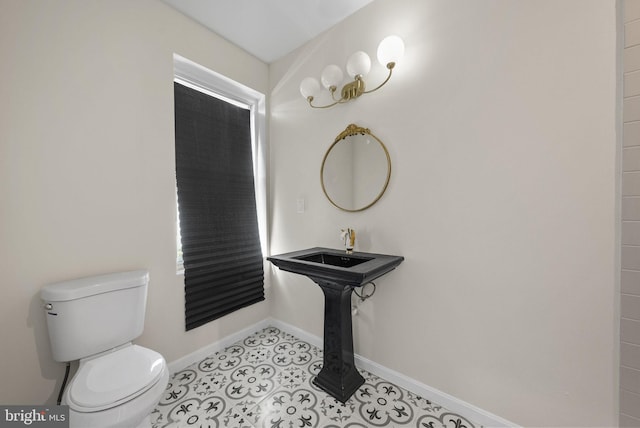 bathroom featuring toilet and tile floors