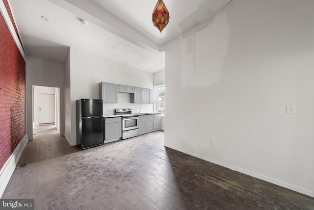 kitchen with black fridge, gray cabinets, range with electric cooktop, and dark wood-type flooring