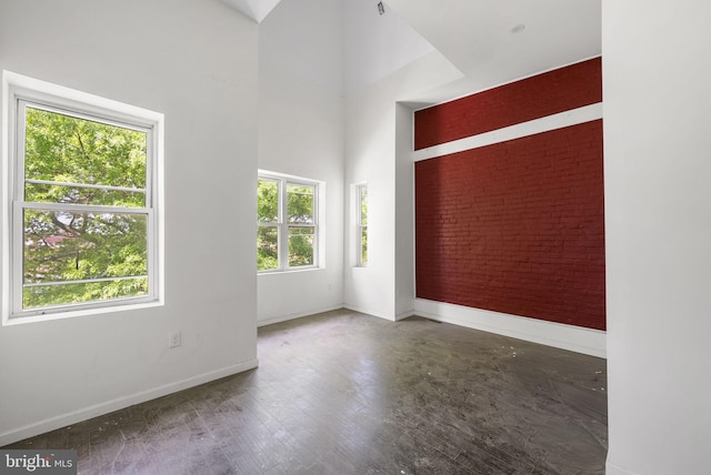 unfurnished room featuring vaulted ceiling and dark hardwood / wood-style flooring