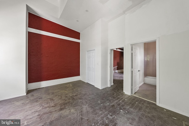 empty room featuring high vaulted ceiling