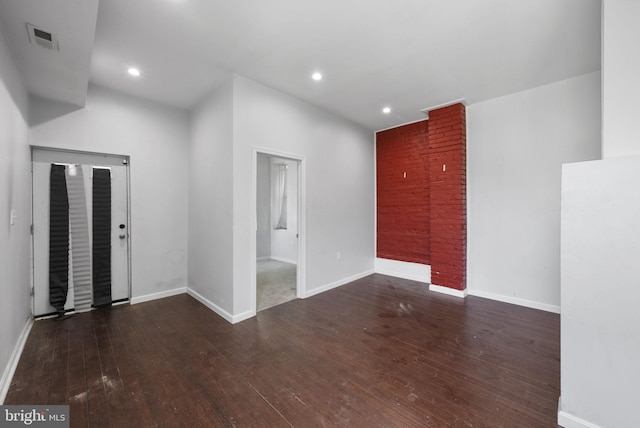 spare room with dark wood-type flooring