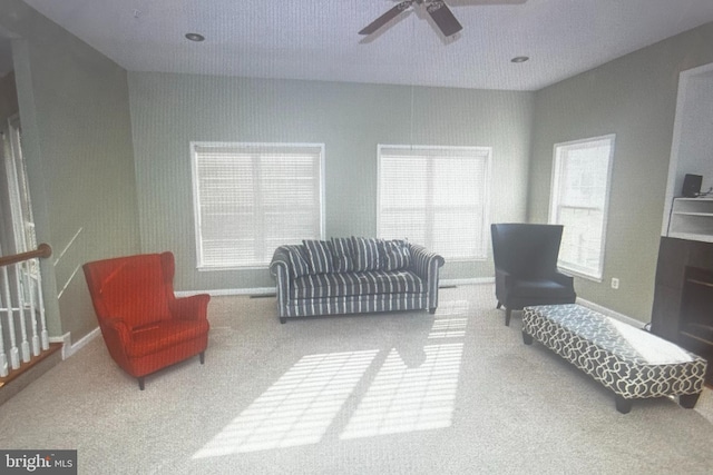 living room featuring carpet and ceiling fan