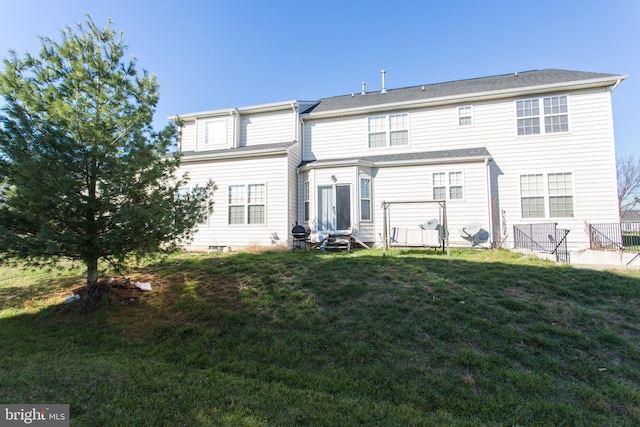 rear view of property with a yard