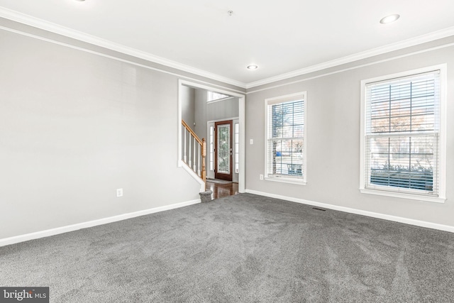 carpeted empty room featuring crown molding