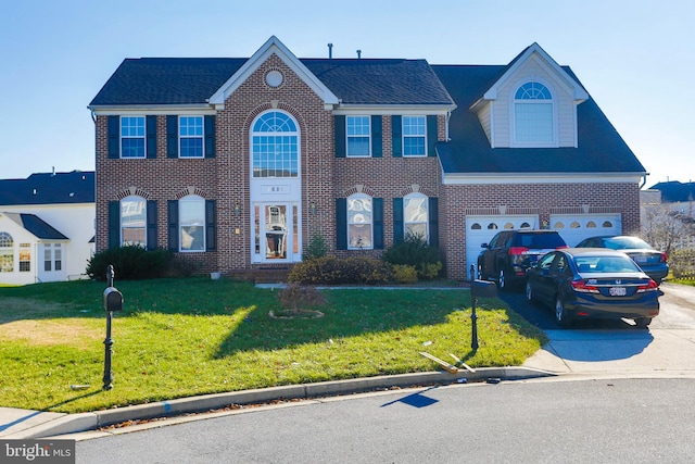 view of front of property featuring a garage and a front lawn