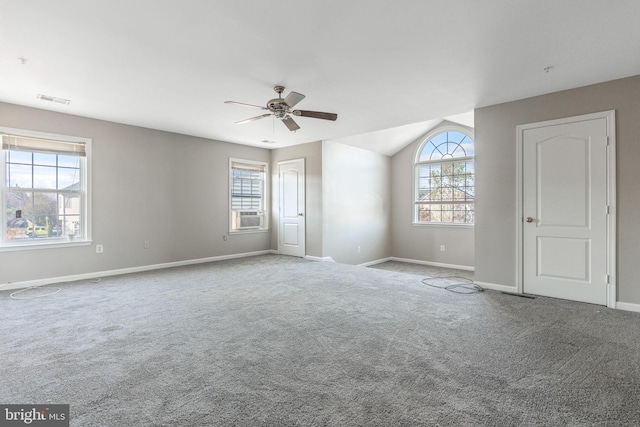 spare room featuring a wealth of natural light and light colored carpet