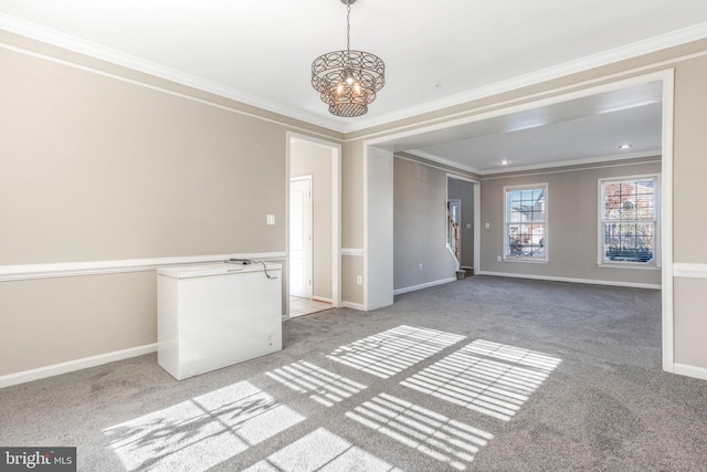 unfurnished room featuring crown molding, carpet flooring, and a chandelier