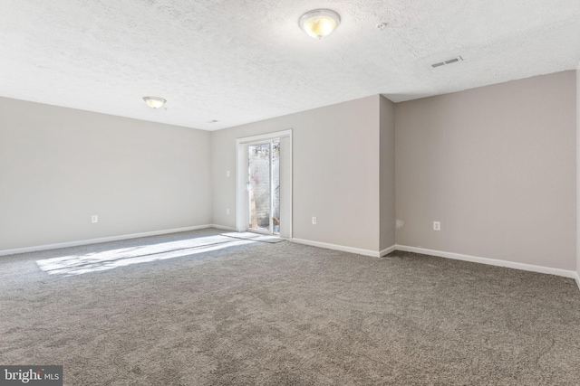 carpeted spare room featuring a textured ceiling