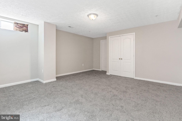 interior space with carpet flooring and a textured ceiling