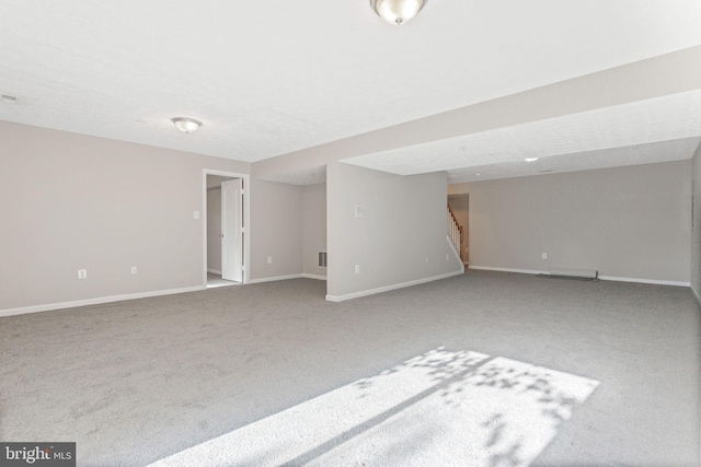 interior space with carpet floors and a textured ceiling