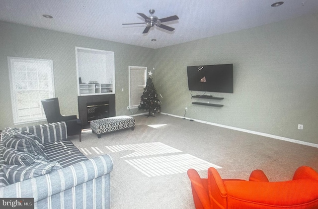 carpeted living room with ceiling fan