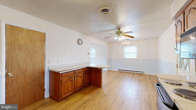 kitchen featuring stainless steel range with electric stovetop, light hardwood / wood-style flooring, kitchen peninsula, baseboard heating, and ceiling fan with notable chandelier