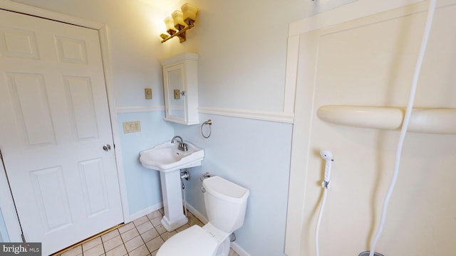 bathroom featuring tile patterned floors and toilet