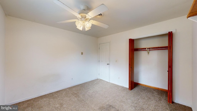 unfurnished bedroom with a closet, ceiling fan, and carpet floors