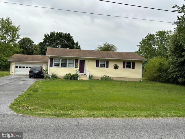 view of front of home featuring a garage and a front lawn