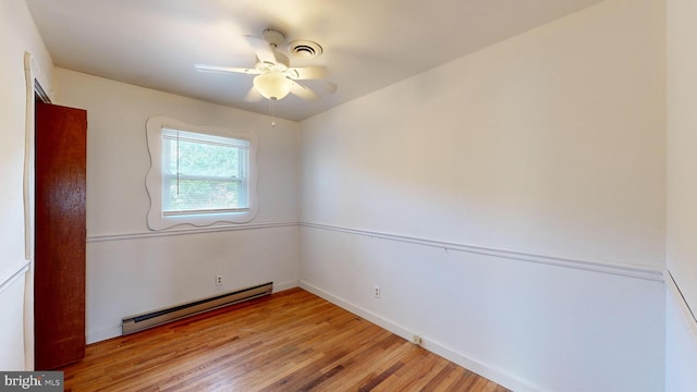 empty room featuring baseboard heating, light hardwood / wood-style flooring, and ceiling fan