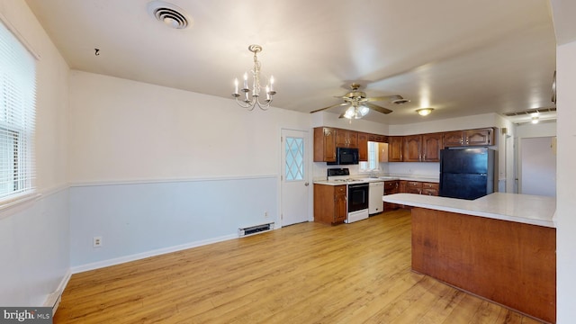 kitchen with pendant lighting, light hardwood / wood-style floors, ceiling fan with notable chandelier, and black appliances