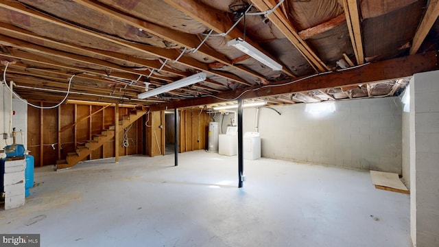 basement featuring washing machine and clothes dryer and gas water heater