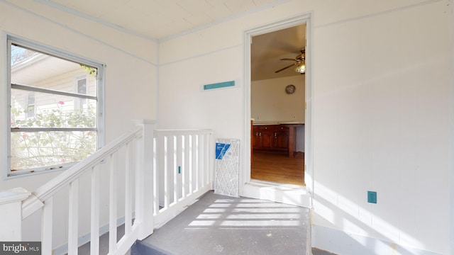 hall featuring a wealth of natural light and concrete flooring