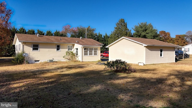 back of house featuring a yard and cooling unit