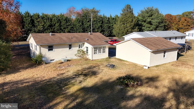 back of property featuring a lawn